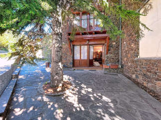 Discover the charm of this stunning property, featuring a beautiful stone facade and a welcoming entrance.