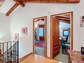 Discover the charm of this inviting property, featuring a bright hallway with access to multiple rooms.