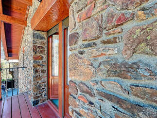 This stunning property boasts a unique stone facade, exuding rustic charm and character.
