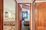 Step into a charming home with this inviting view of multiple bedrooms.