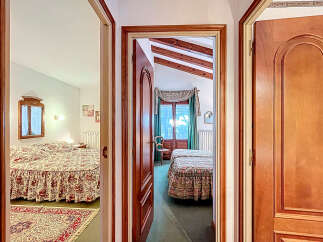 Step into a charming home with this inviting view of multiple bedrooms.
