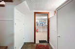 Discover the charm of this property, featuring a well-lit hallway with ample storage solutions.
