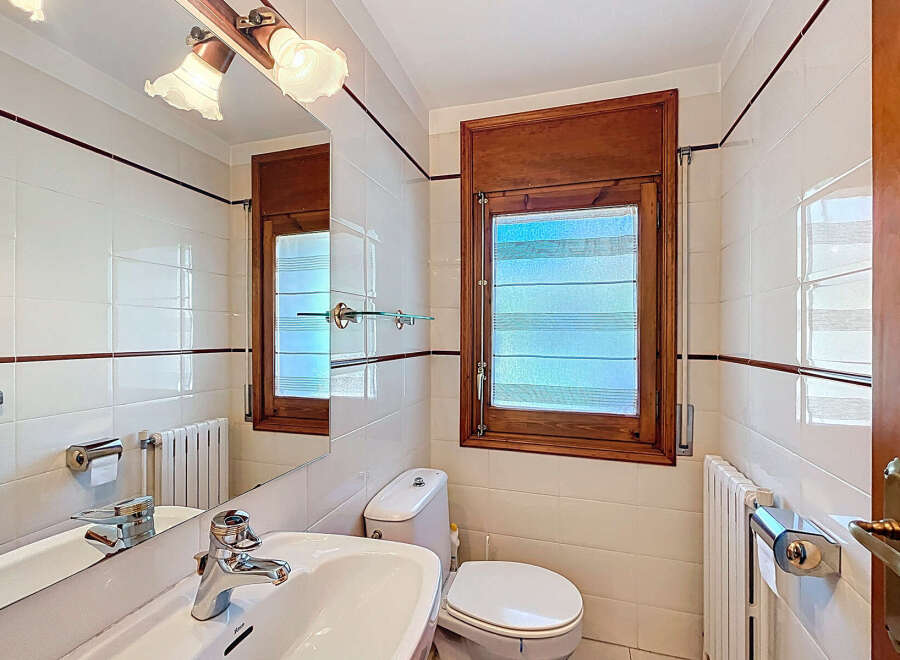 This charming bathroom features a bright and airy design, perfect for starting your day.