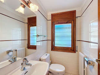 This charming bathroom features a bright and airy design, perfect for starting your day.