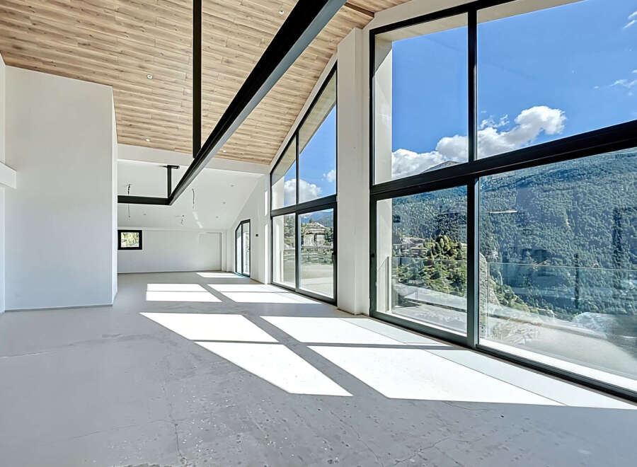 Experience luxury living in this stunning property, featuring expansive windows that frame breathtaking mountain views.