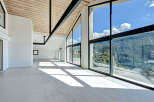 Experience luxury living in this stunning property, featuring expansive windows that frame breathtaking mountain views.
