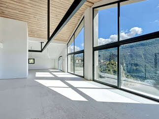 Experience luxury living in this stunning property, featuring expansive windows that frame breathtaking mountain views.