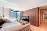 Experience luxury living in this stunning bedroom with breathtaking mountain views.