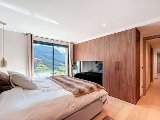 Experience luxury living in this stunning bedroom with breathtaking mountain views.