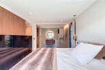 Step into luxury with this stunning bedroom featuring a seamless blend of modern design and comfort.