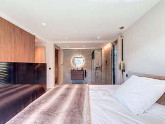 Step into luxury with this stunning bedroom featuring a seamless blend of modern design and comfort.