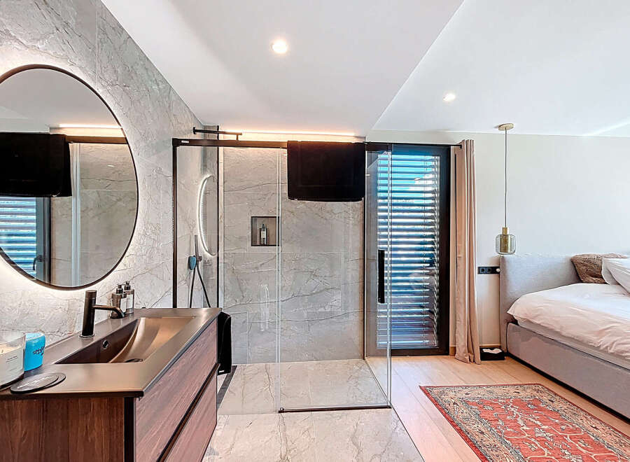 Experience luxury living in this stunning property featuring a modern bathroom with a sleek shower and a stylish vanity.