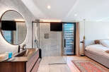 Experience luxury living in this stunning property featuring a modern bathroom with a sleek shower and a stylish vanity.