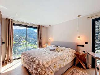 Experience luxury living in this stunning bedroom with breathtaking mountain views.