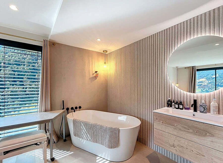 Experience luxury in this stunning bathroom, featuring a modern freestanding tub and a stylish vanity.
