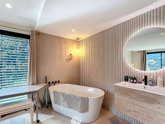 Experience luxury in this stunning bathroom, featuring a modern freestanding tub and a stylish vanity.