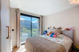 Experience breathtaking views from this stunning bedroom! This property boasts a large window that frames the picturesque landscape, creating a serene and inviting atmosphere.