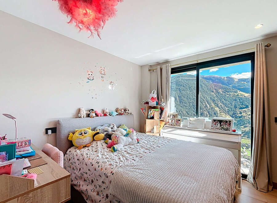 This charming bedroom offers a cozy retreat with stunning mountain views.