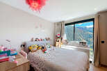 This charming bedroom offers a cozy retreat with stunning mountain views.