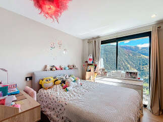 This charming bedroom offers a cozy retreat with stunning mountain views.