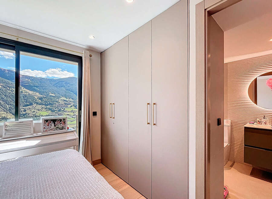Experience luxury living with this stunning property, featuring a bedroom with breathtaking mountain views.