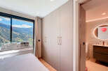 Experience luxury living with this stunning property, featuring a bedroom with breathtaking mountain views.