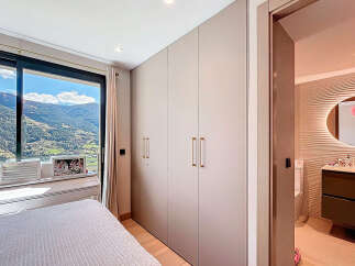 Experience luxury living with this stunning property, featuring a bedroom with breathtaking mountain views.