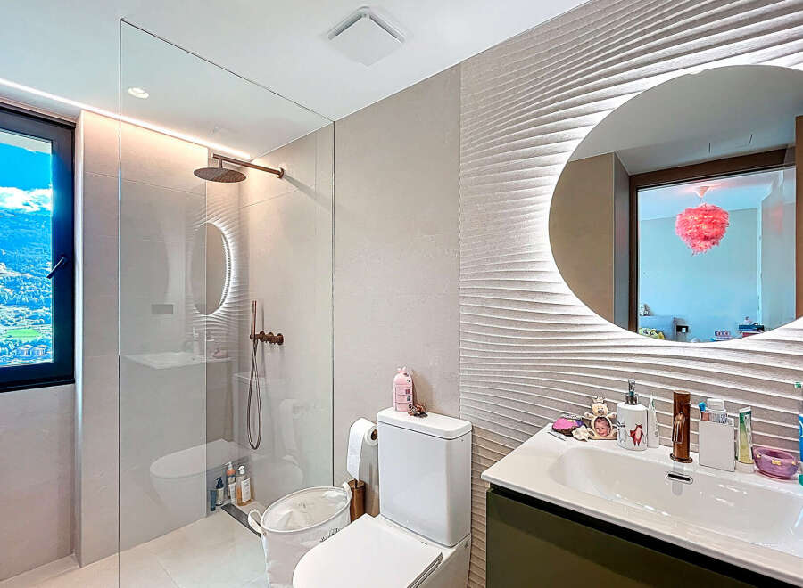 Step into a luxurious bathroom oasis! This stunning space features a modern design with a sleek glass shower enclosure and elegant fixtures.