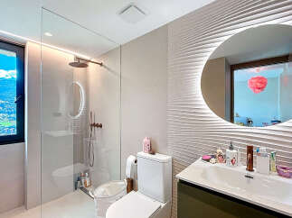 Step into a luxurious bathroom oasis! This stunning space features a modern design with a sleek glass shower enclosure and elegant fixtures.