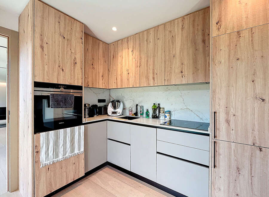 Experience modern elegance in this stunning kitchen, featuring custom wood cabinetry and sleek, minimalist design.