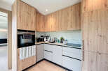 Experience modern elegance in this stunning kitchen, featuring custom wood cabinetry and sleek, minimalist design.