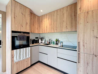 Experience modern elegance in this stunning kitchen, featuring custom wood cabinetry and sleek, minimalist design.