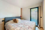 This bedroom offers a serene retreat with its comfortable bed and inviting ambiance.