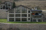 This stunning modern home showcases a unique design with a stone facade and expansive windows, offering breathtaking views.