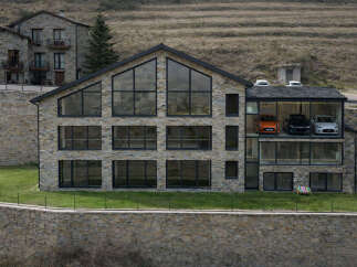 This stunning modern home showcases a unique design with a stone facade and expansive windows, offering breathtaking views.
