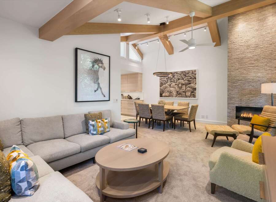 Experience luxury living in this stunning property, featuring a spacious living area with a cozy fireplace and elegant furnishings.