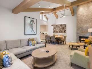 Experience luxury living in this stunning property, featuring a spacious living area with a cozy fireplace and elegant furnishings.