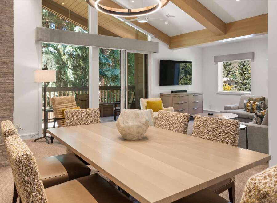 Experience luxury living in this stunning property, featuring a spacious dining area with a modern design.