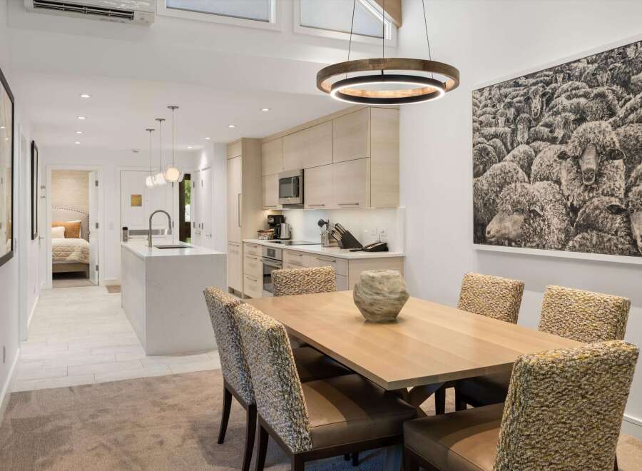 This stunning property boasts a modern kitchen with sleek cabinetry and top-of-the-line appliances, perfect for culinary enthusiasts.