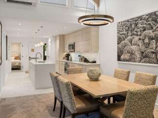 This stunning property boasts a modern kitchen with sleek cabinetry and top-of-the-line appliances, perfect for culinary enthusiasts.