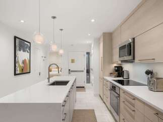 Experience modern luxury in this stunning kitchen! Featuring sleek cabinetry, a spacious island, and high-end appliances, this space is perfect for both cooking and entertaining.