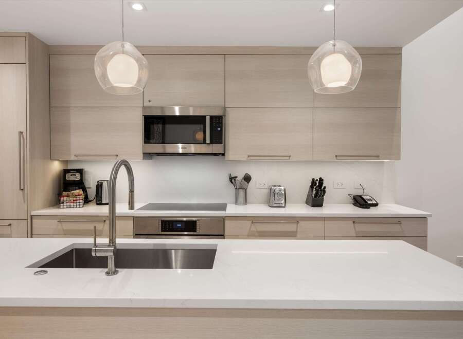 This modern kitchen boasts sleek design and high-end appliances, perfect for culinary enthusiasts.