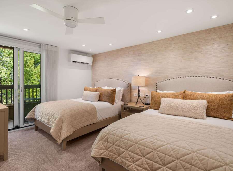Experience luxury in this stunning bedroom featuring two comfortable beds with plush bedding.