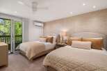 Experience luxury in this stunning bedroom featuring two comfortable beds with plush bedding.