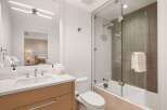 Step into luxury with this stunning bathroom, featuring a sleek glass shower enclosure and modern fixtures.