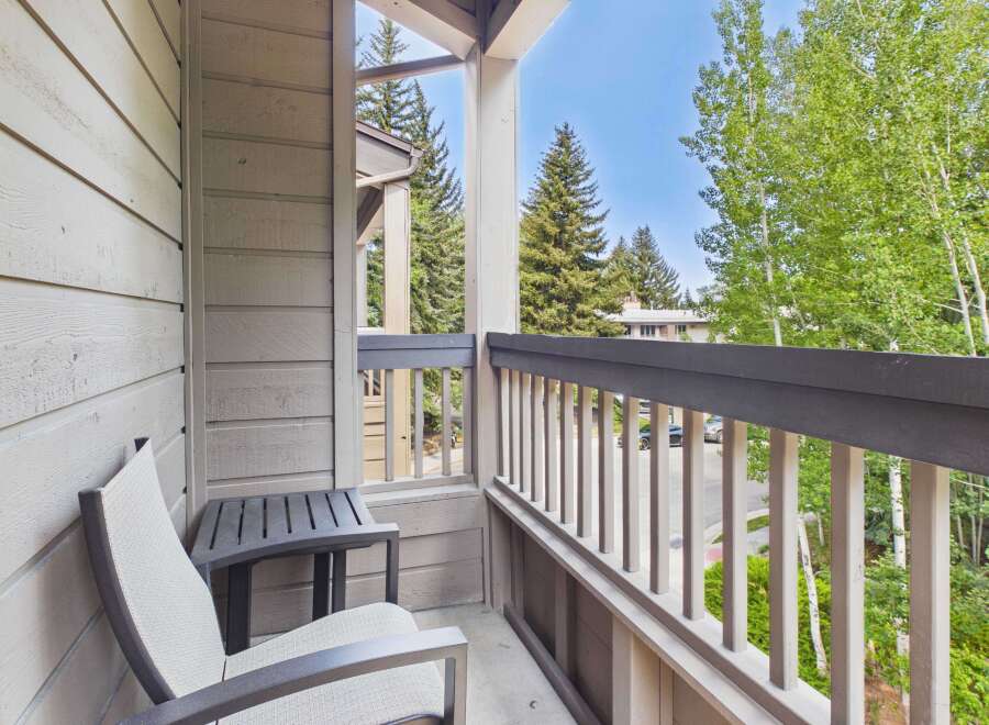 Enjoy your morning coffee or evening relaxation on this charming balcony, complete with comfortable seating and a side table.