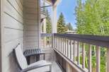 Enjoy your morning coffee or evening relaxation on this charming balcony, complete with comfortable seating and a side table.