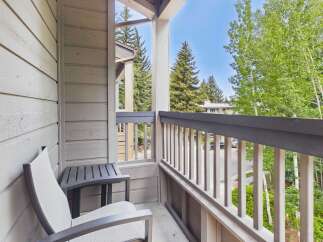 Enjoy your morning coffee or evening relaxation on this charming balcony, complete with comfortable seating and a side table.