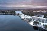Discover a stunning waterfront property nestled amidst a serene winter landscape.