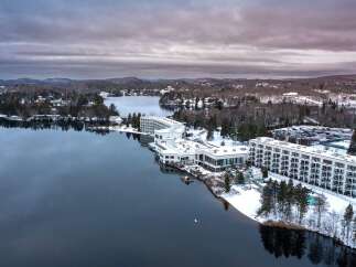 Discover a stunning waterfront property nestled amidst a serene winter landscape.